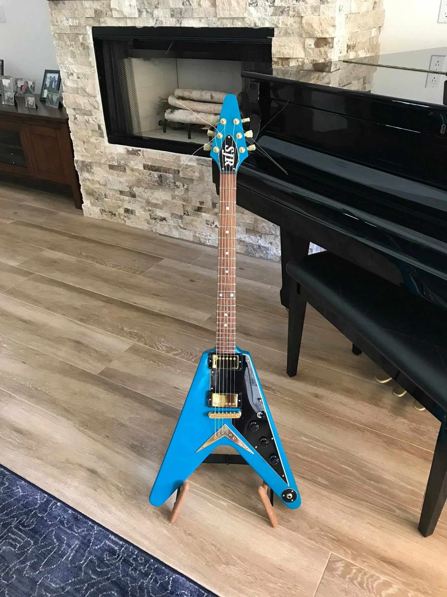 Blue SJR-SRV guitar standing in an interior